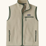 Patagonia men's retro pile vest in beige with a green trim. A warm fleece gilet with a front zip, chest and side pockets