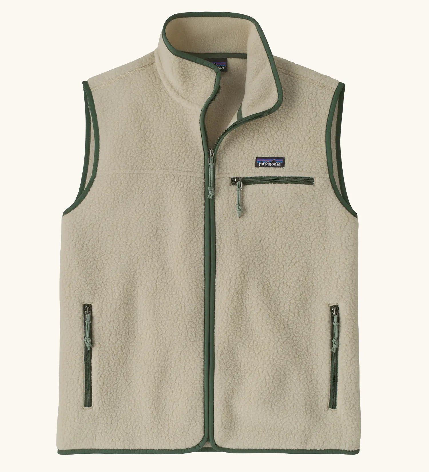 Patagonia men's retro pile vest in beige with a green trim. A warm fleece gilet with a front zip, chest and side pockets