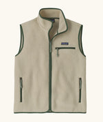 Patagonia men's retro pile vest in beige with a green trim. A warm fleece gilet with a front zip, chest and side pockets