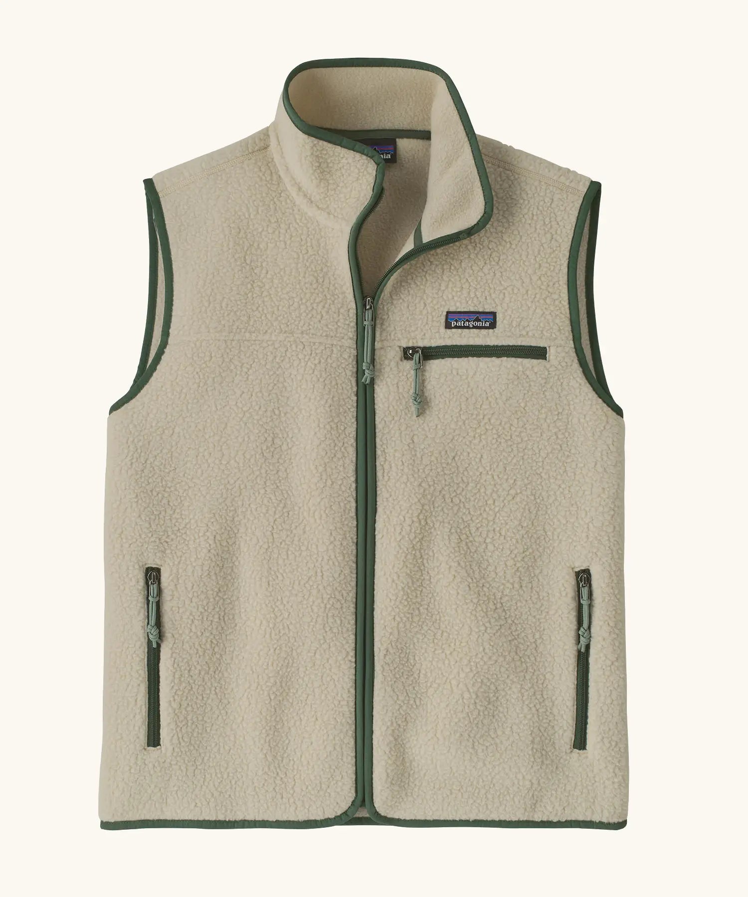 Patagonia men's retro pile vest in beige with a green trim. A warm fleece gilet with a front zip, chest and side pockets