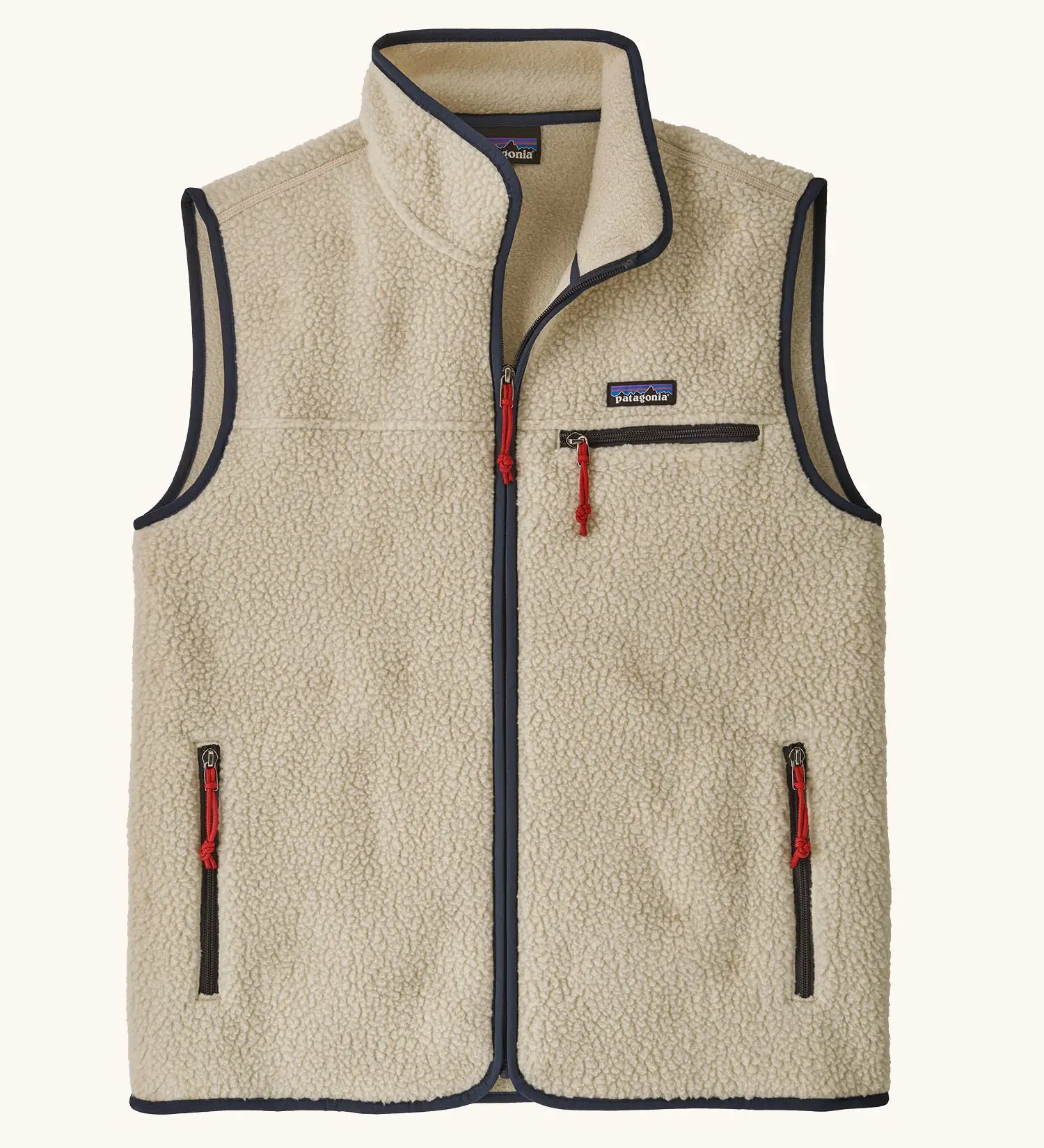 Patagonia men's retro pile fleece vest in beige with a dark blue trim. Features a full front zip, chest and side pockets
