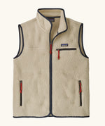 Patagonia men's retro pile fleece vest in beige with a dark blue trim. Features a full front zip, chest and side pockets