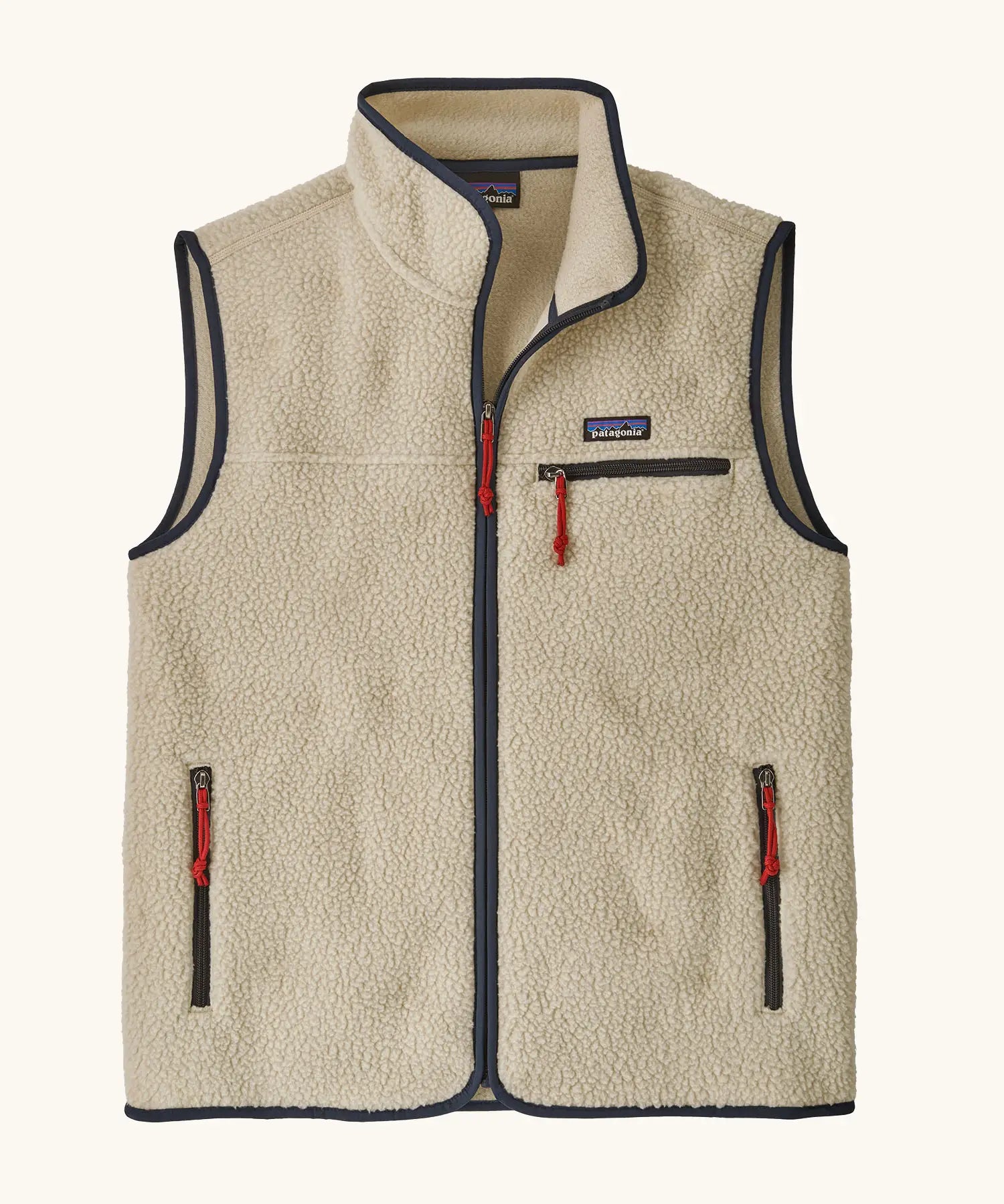Patagonia men's retro pile fleece vest in beige with a dark blue trim. Features a full front zip, chest and side pockets