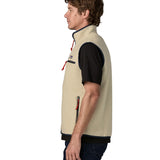 Side of man wearing Patagonia men's retro pile vest in beige with a navy trim. Gilet features a turned up collar