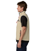 Side of man wearing Patagonia men's retro pile vest in beige with a navy trim. Gilet features a turned up collar