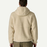 Back view of a man wearing the Patagonia Men’s Retro-X Fleece Hoody Jacket in Dark Natural, showing the hood and high pile fleece across the back.