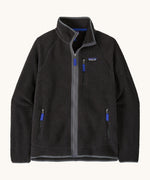 Patagonia men's retro pile fleece jacket in black/forge grey colour. A thick black fleece with grey trim. Features a full length zip and turn up collar, 2 side pockets and a chest pocket with the brand patch stitched on the chest.