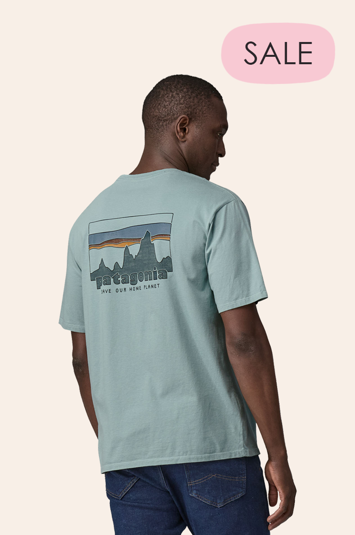 Man wearing a Patagonia t-shirt on cream background to represent Patagonia men's sale at Babipur.