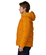 Side of man wearing Patagonia water repellent sisar thick down jacket in orange. Coat has a relaxed fir and sits at the hips