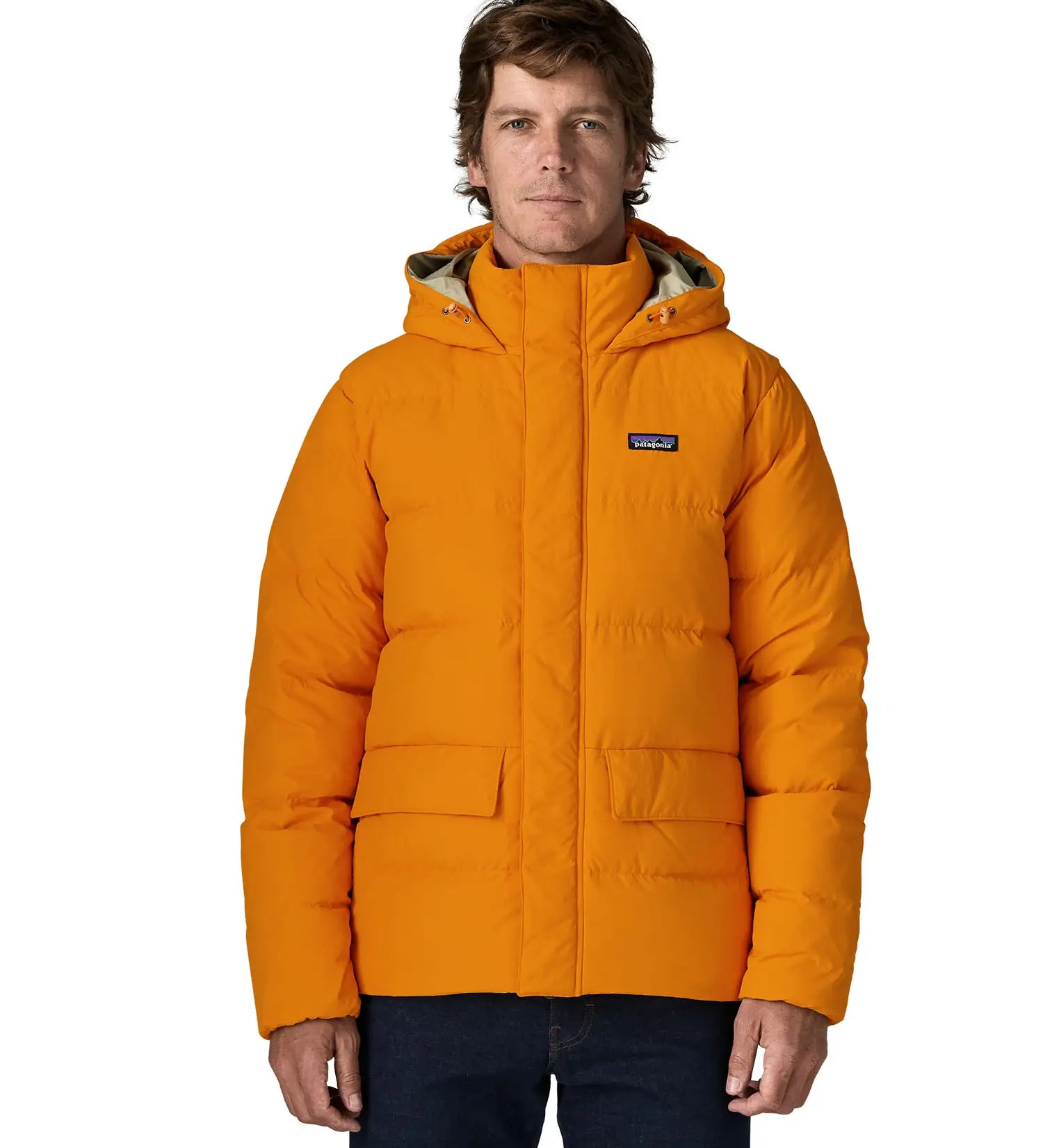 Man wearing Patagonia lightweight water repellent sisar thick down jacket in orange showing togs on adjustable hood