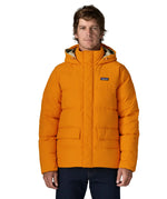 Man wearing Patagonia lightweight water repellent sisar thick down jacket in orange showing togs on adjustable hood