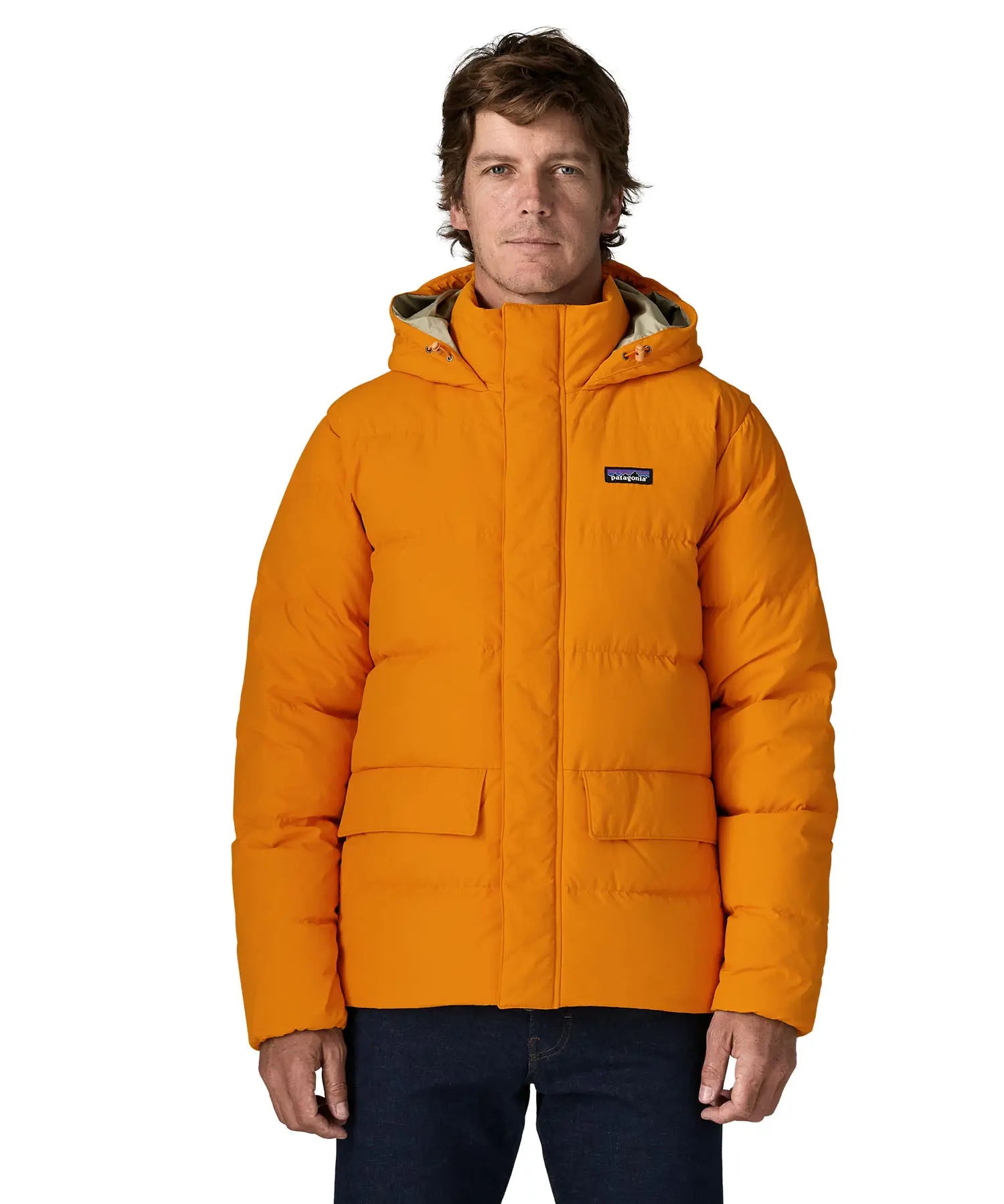 Man wearing Patagonia lightweight water repellent sisar thick down jacket in orange showing togs on adjustable hood