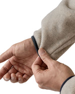 Close up of man pulling on the elasticated cuff on the Patagonia synchilla snap t fleece