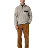 Man wearing Patagonia's recycled polyester synchilla snap t fleece in light grey. Shows a 1/4 length front popper from the collar