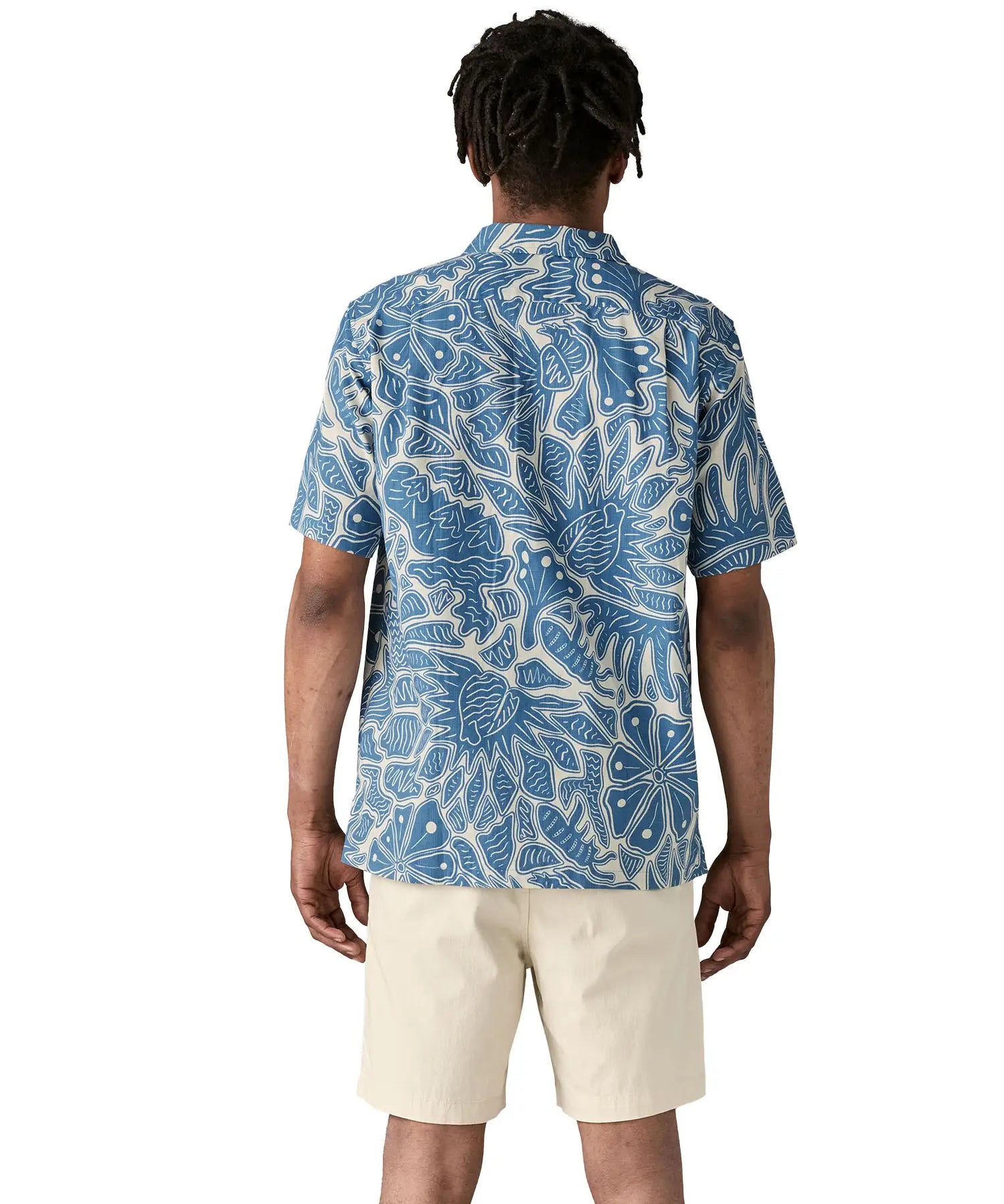 Back of man wearing Patagonia men's tidal  short sleeve shirt with light blue and cream Hawaiian inspired floral prints.