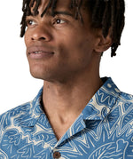 Man wearing Patagonia men's tidal threads short sleeve shirt with light blue and cream Hawaiia inspired prints showing collar detail