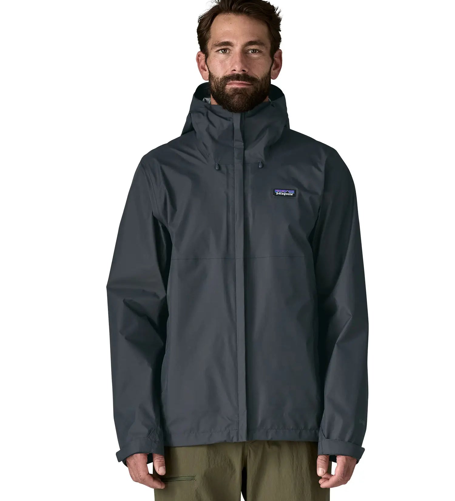 Front of man wearing the Patagonia men's waterproof torrentshell 3 layer rain hooded jacket in smolder blue. Jacket has a relaxed fit