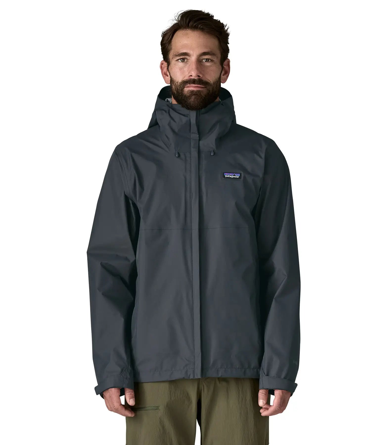 Front of man wearing the Patagonia men's waterproof torrentshell 3 layer rain hooded jacket in smolder blue. Jacket has a relaxed fit