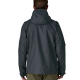 Back of man wearing the Patagonia men's torrentshell 3 layer rain jacket in smolder blue. Jacket has a relaxed fit