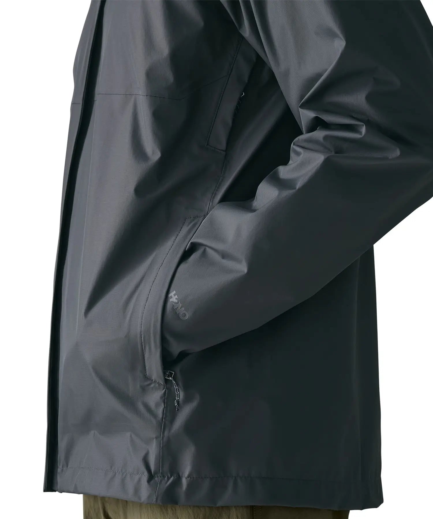 Side of man wearing the Patagonia men's torrentshell 3 layer rain jacket in smolder blue. Showing close up hand in the handwarmer pocket