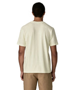 Back of man wearing Patagonia's men's trail harbour short sleeve tee in cream. T-shirt has a relaxed fit and sits at the hips