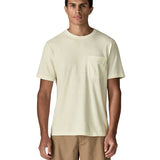 Man wearing Patagonia's men's trail harbour short sleeve tee in cream showing front pouch chest pocket