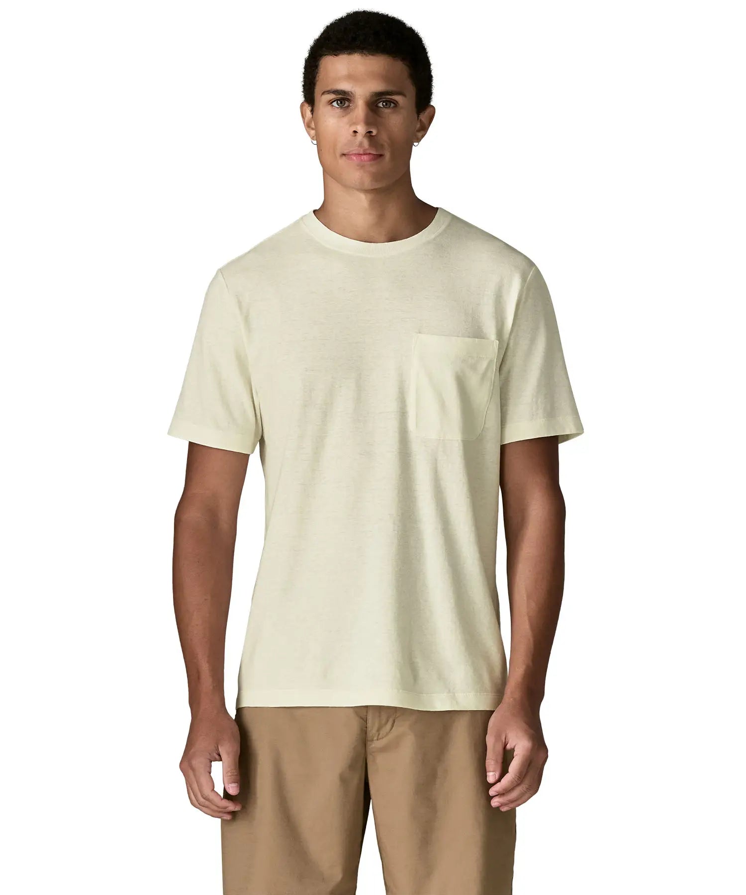 Man wearing Patagonia's men's trail harbour short sleeve tee in cream showing front pouch chest pocket