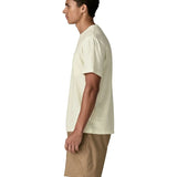 Side of man Man wearing Patagonia's men's trail harbour short sleeve tee in cream. T-shirt has a relaxed fit