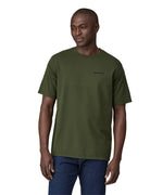 Dark green Patagonia Short sleeve t-shirt being worn my an adult. The front of the t-shirt has the word "Patagonia" in small writing