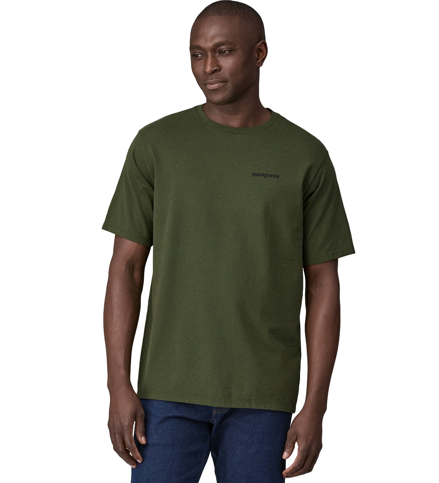 Dark green Patagonia Short sleeve t-shirt being worn my an adult. The front of the t-shirt has the word "Patagonia" in small writing