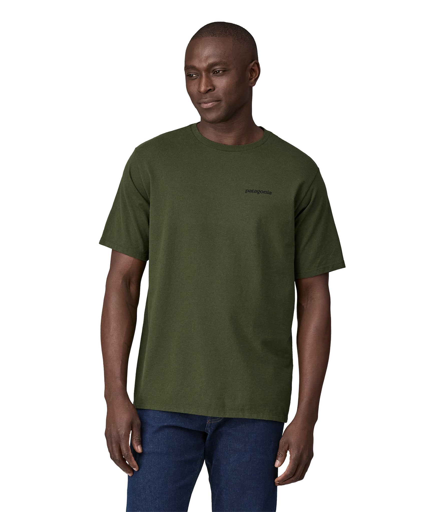 Dark green Patagonia Short sleeve t-shirt being worn my an adult. The front of the t-shirt has the word "Patagonia" in small writing