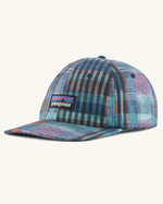 Patagonia p6 label trad cap with a blue abstract check pattern design. Shows air holes on the top and brand patch on the front