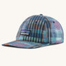 Patagonia p6 label trad cap with a blue abstract check pattern design. Shows air holes on the top and brand patch on the front
