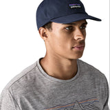 Man wearing Patagonia's p6 label trad cap with navy. Cap has a baseball style and low crown fit