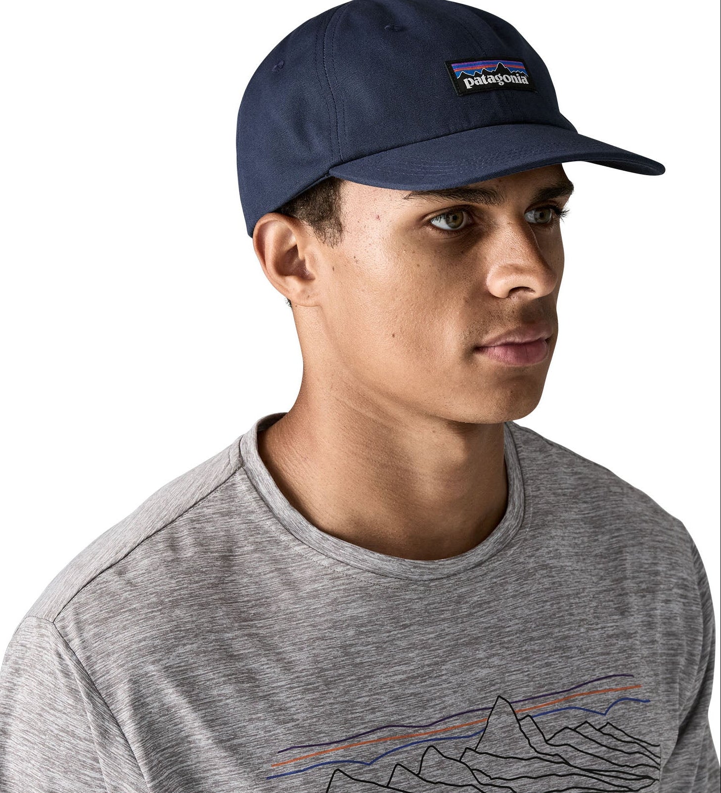 Man wearing Patagonia's p6 label trad cap with navy. Cap has a baseball style and low crown fit