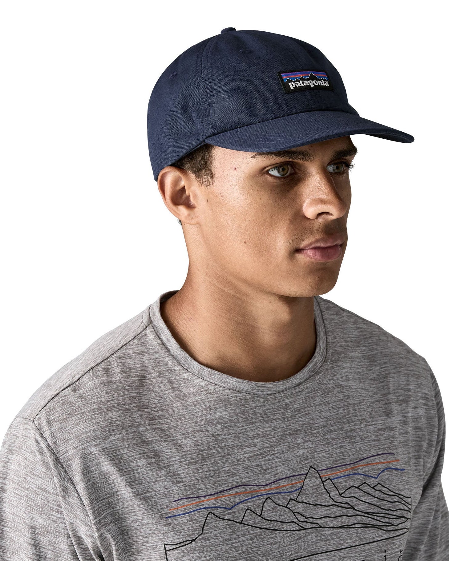 Man wearing Patagonia's p6 label trad cap with navy. Cap has a baseball style and low crown fit