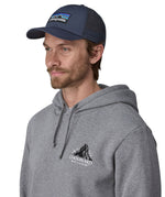 Man wearing Patagonia's p6 logo lopro trucker hat in navy, shows the breathable mesh back panel.