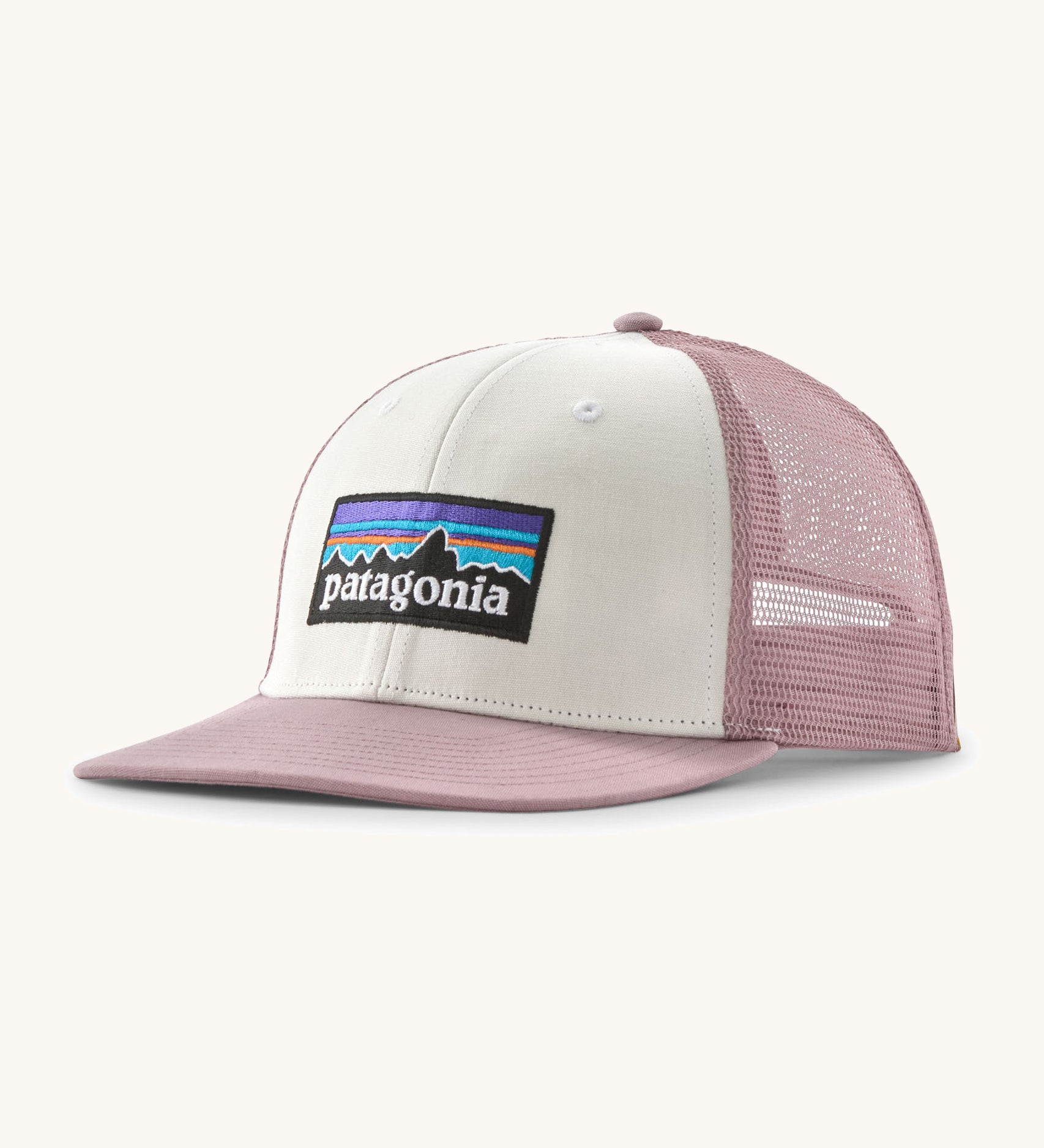 Patagonia p6 logo trucker hat in white with a pink breathable mesh back panel and visor