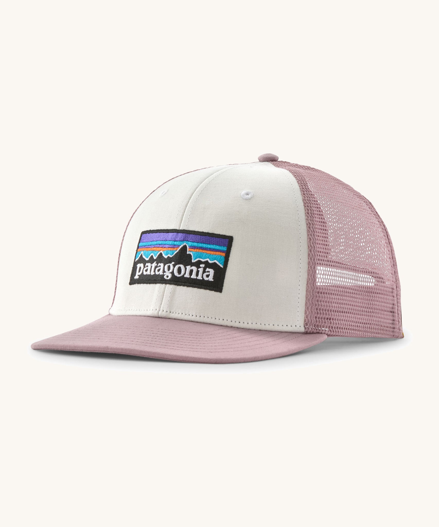 Patagonia p6 logo trucker hat in white with a pink breathable mesh back panel and visor