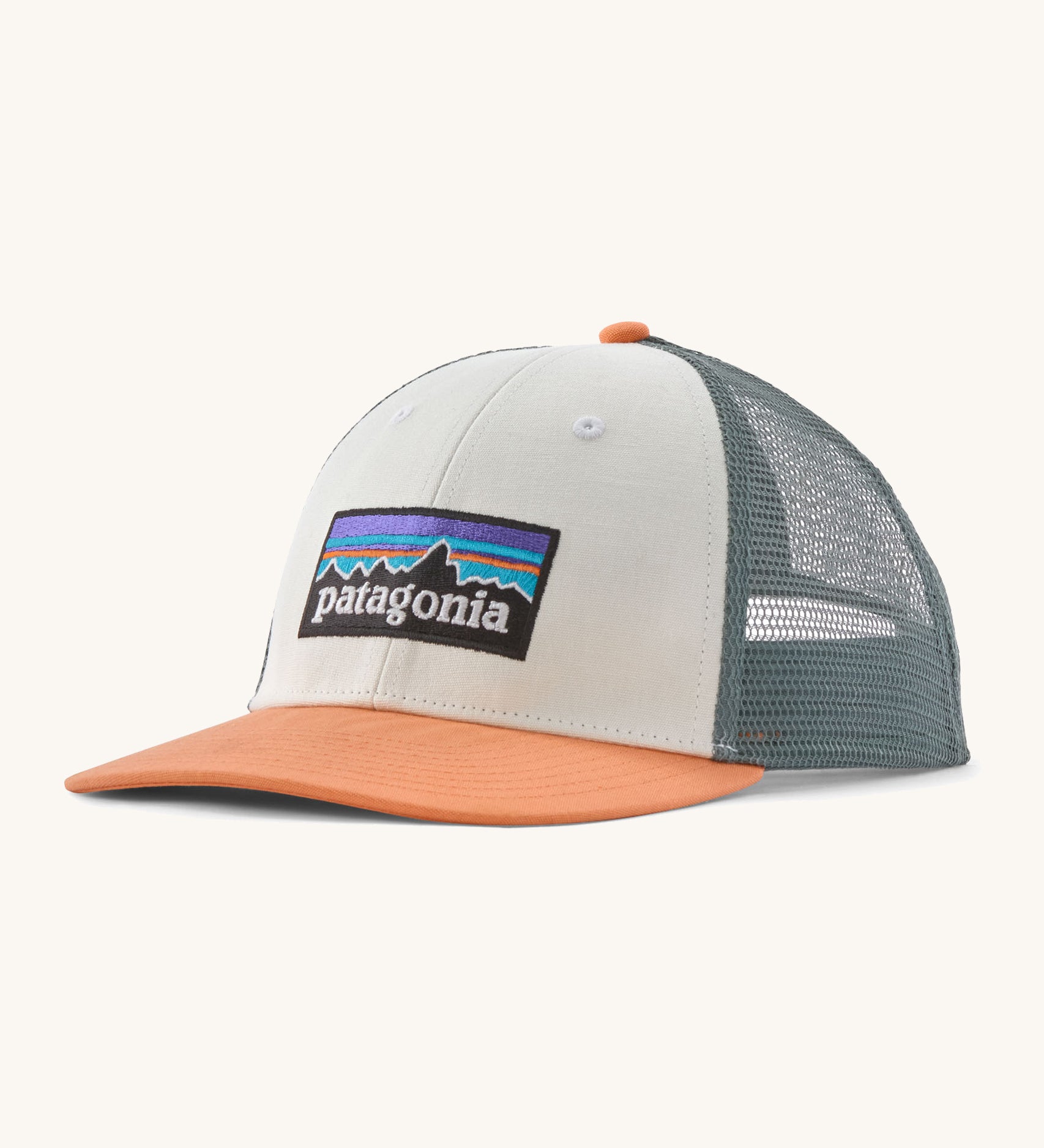 Patagonia p6 logo lopro trucker hat in white with a breathable blue mesh back panel and orange bill
