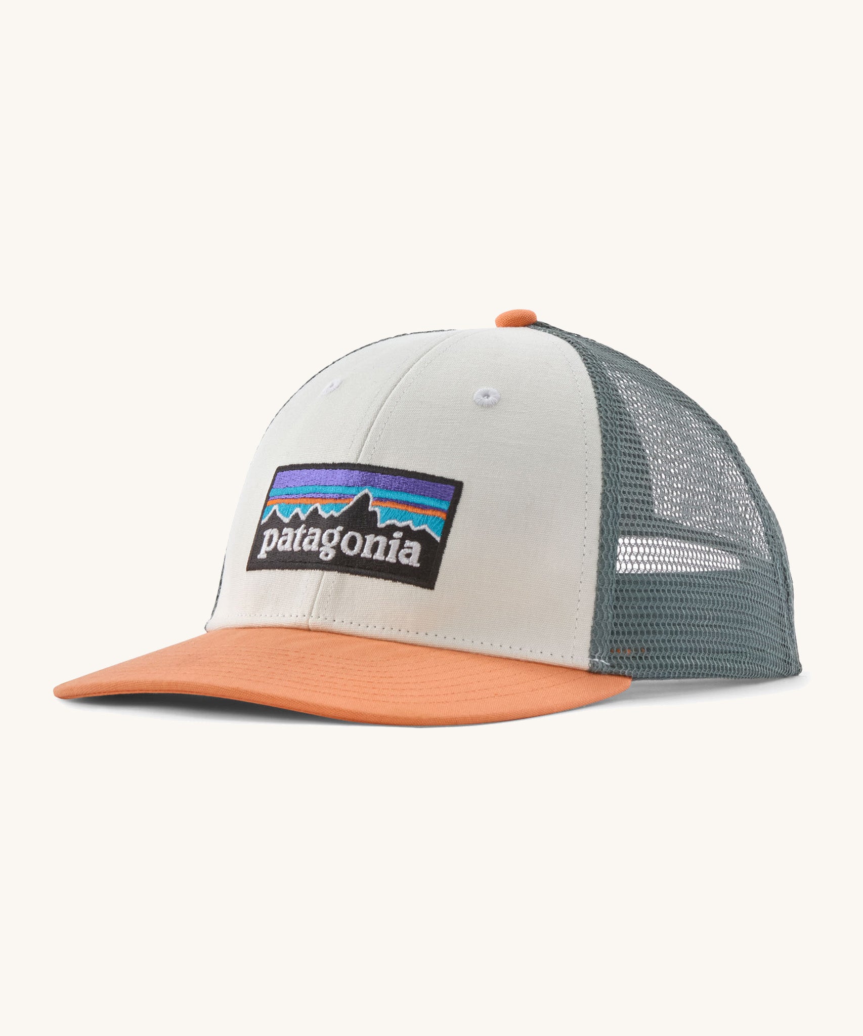 Patagonia p6 logo lopro trucker hat in white with a breathable blue mesh back panel and orange bill