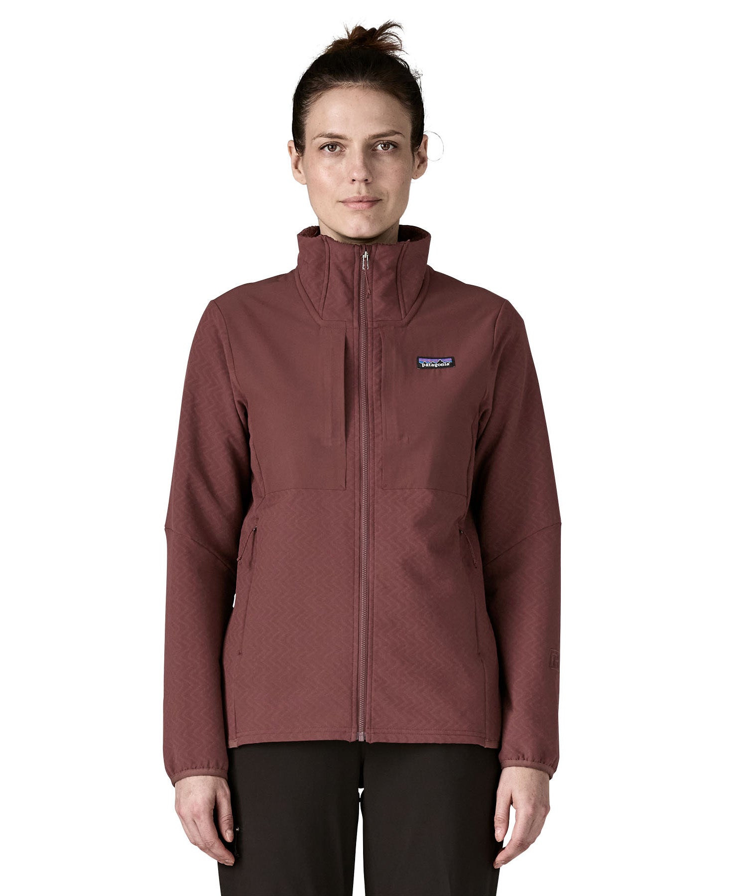 A woman wearing the Patagonia R2 crossstrata jacket in dark ruby available at Babipur. A technical jacket in dark red with   2 side pockets and easy access chest pockets