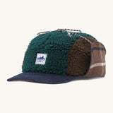 Patagonia adult range cap in cascade green available at Babipur. Showing the a check style front panel and features earflaps to keep the ears warm and a tie to keep them up. 
