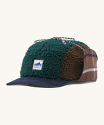 Patagonia adult range cap in cascade green available at Babipur. Showing the a check style front panel and features earflaps to keep the ears warm and a tie to keep them up. 