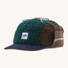 Patagonia adult range cap in cascade green available at Babipur. Showing the a check style front panel and features earflaps to keep the ears warm and a tie to keep them up. 