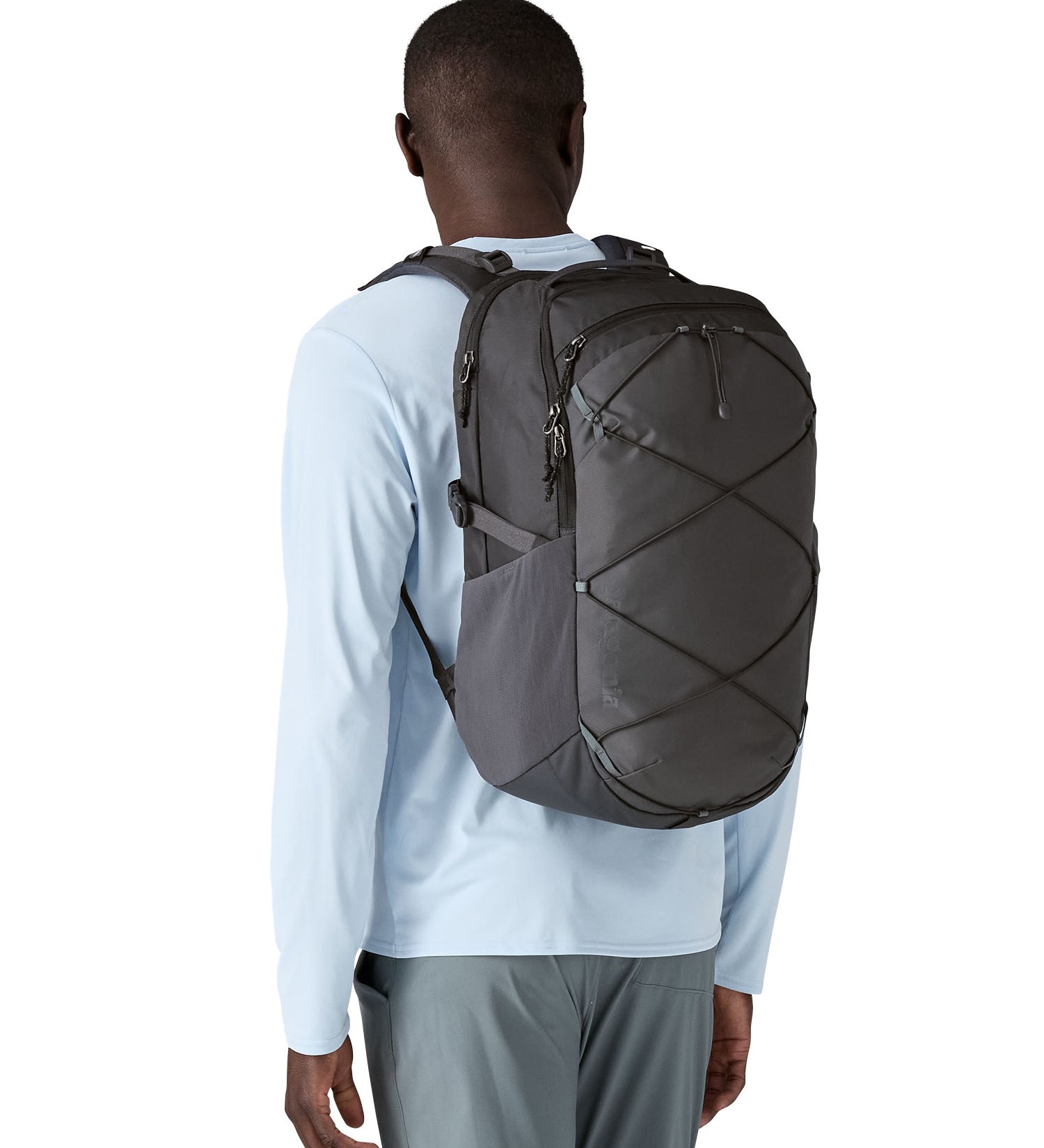 A person wearing the Patagonia Refugio Day Pack 30L  Smolder Blue, showing the front of the bag