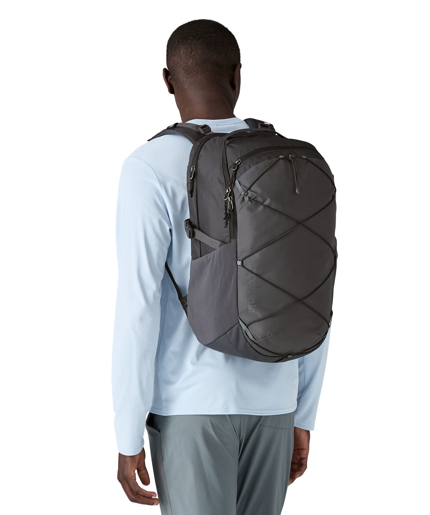 A person wearing the Patagonia Refugio Day Pack 30L  Smolder Blue, showing the front of the bag