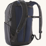 The back of the Patagonia Refugio Day Pack 30L  Smolder Blue, showing the shoulder straps and the chest strap closed