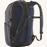 The back of the Patagonia Refugio Day Pack 30L  Smolder Blue, showing the shoulder straps and the chest strap closed