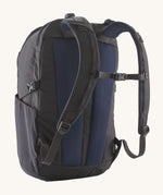The back of the Patagonia Refugio Day Pack 30L  Smolder Blue, showing the shoulder straps and the chest strap closed